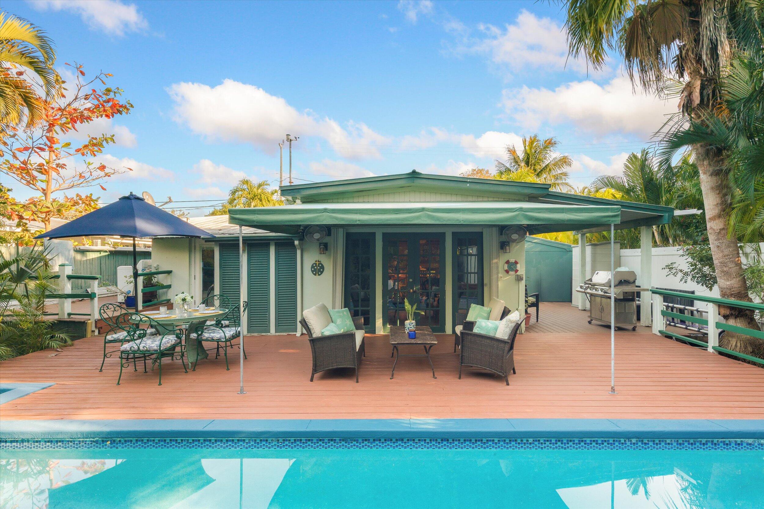 1713 Rose Street Key West, FL 33040 - Photo 43 of 44 a view of a patio with table and chairs potted plants and a large tree