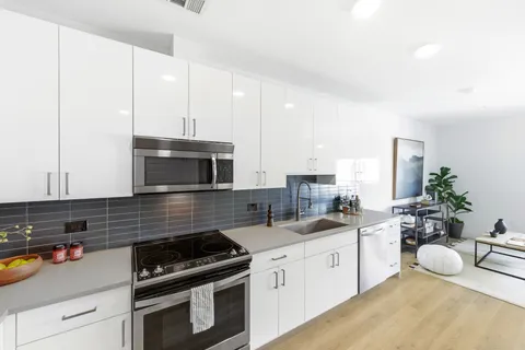 a kitchen with a sink stove and cabinets