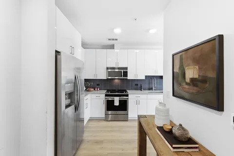 a kitchen with stainless steel appliances granite countertop a stove and a refrigerator