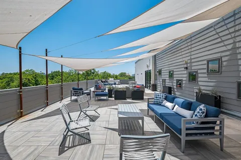 a roof deck with table and chairs