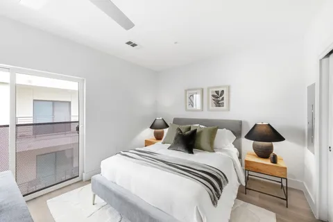 a bedroom with a bed and a painting on the wall