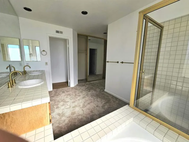 a view of a bathroom with sink and shower