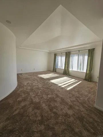 an empty room with large windows