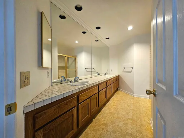 a large bathroom with a sink and a large mirror