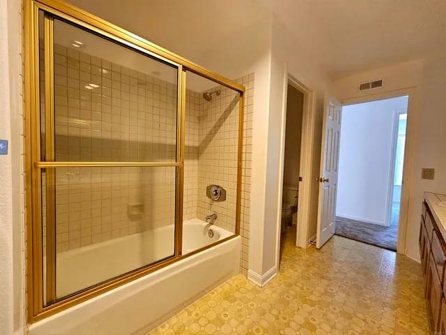 a bathroom with a glass shower door