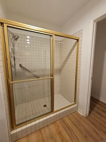 a bathroom with a glass shower door