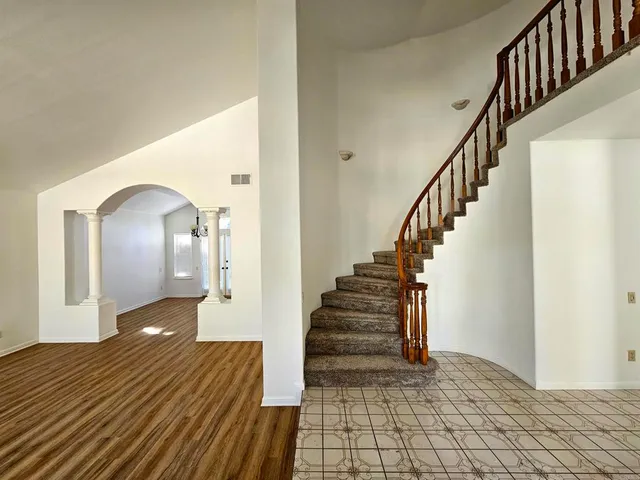 a view of entryway and hall with wooden floor