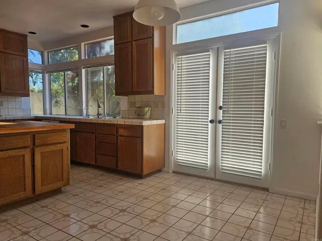 a kitchen with a sink window and cabinets
