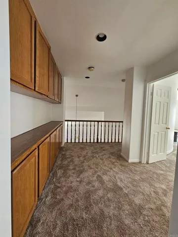 a view of a hallway with stairs