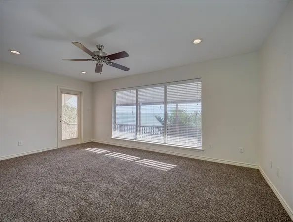 a view of a livingroom with a ceiling fan and window