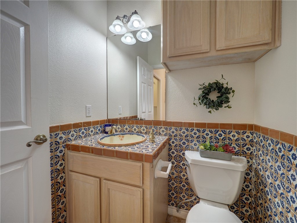 1343 Bayview Drive Portland, TX 78374 - Photo 35 of 36 a bathroom with a sink a toilet and a mirror