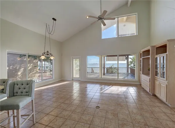 a big room with chandelier and windows