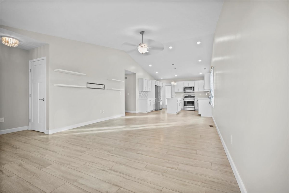 52 Winding Way Bloomington, IL 61705 - Photo 13 of 51 an empty space with kitchen view and wooden floor