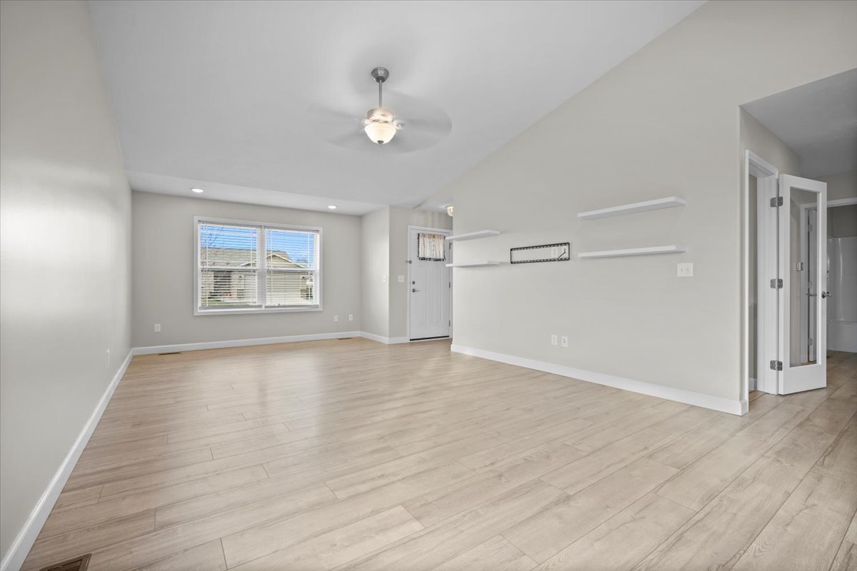 52 Winding Way Bloomington, IL 61705 - Photo 14 of 51 an empty room with wooden floor cabinet and windows