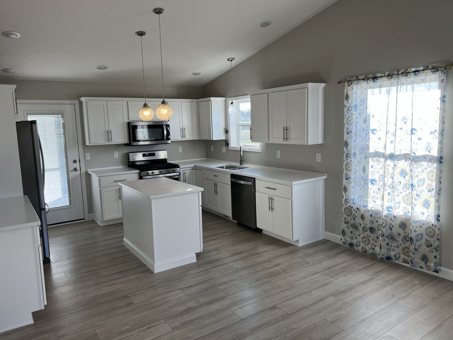 52 Winding Way Bloomington, IL 61705 - Photo 16 of 51 a kitchen with stainless steel appliances a microwave a stove a sink dishwasher a refrigerator white cabinets and wooden floor