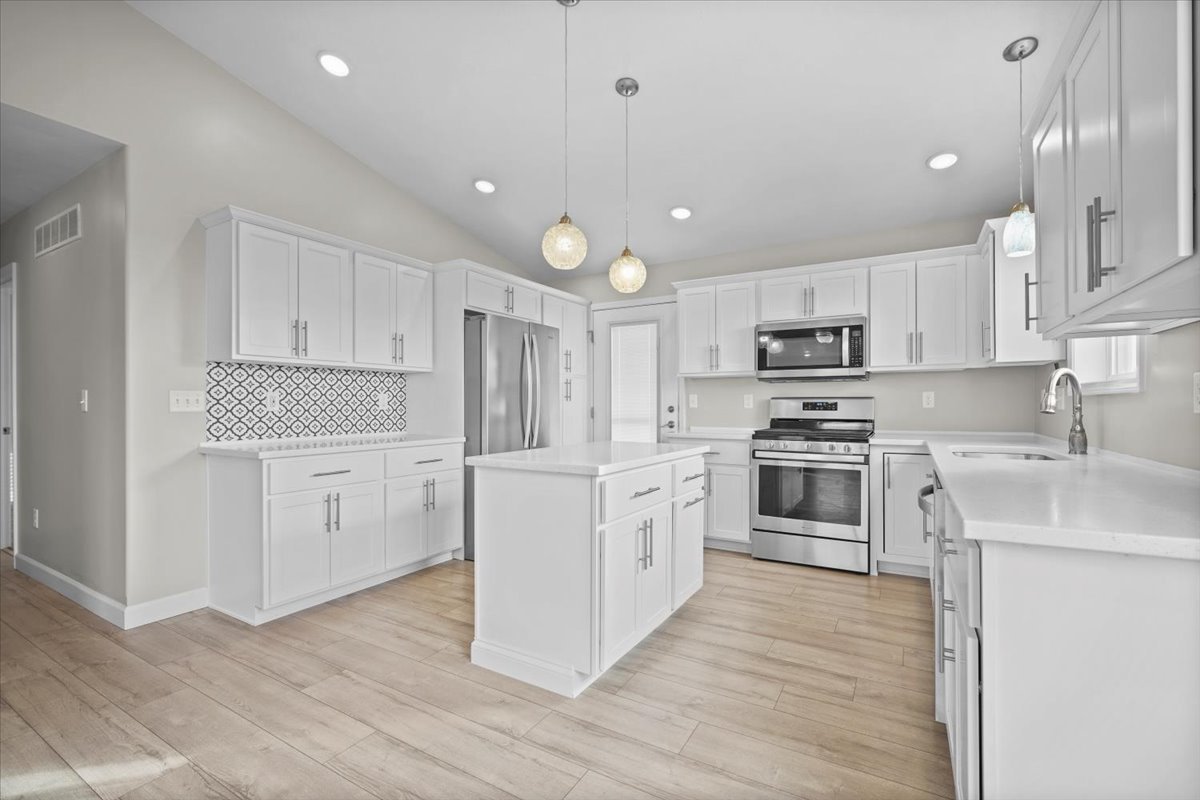 52 Winding Way Bloomington, IL 61705 - Photo 18 of 51 a kitchen with white cabinets stainless steel appliances and sink