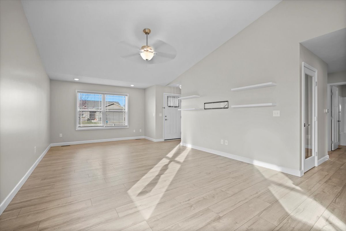 52 Winding Way Bloomington, IL 61705 - Photo 21 of 51 an empty room with wooden floor chandelier and windows