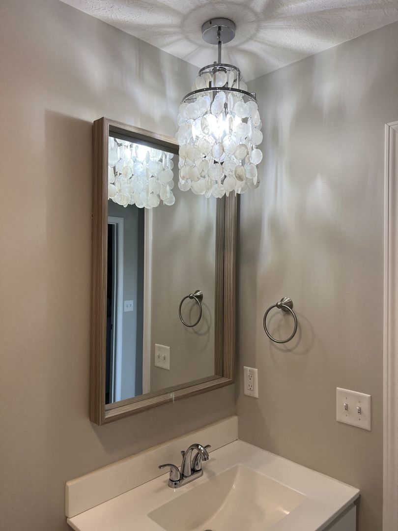 52 Winding Way Bloomington, IL 61705 - Photo 29 of 51 a bathroom with a mirror a sink and shower