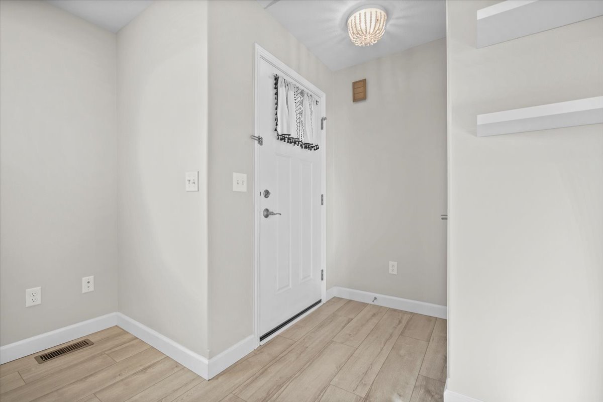 52 Winding Way Bloomington, IL 61705 - Photo 10 of 51 a view of an empty room with wooden floor