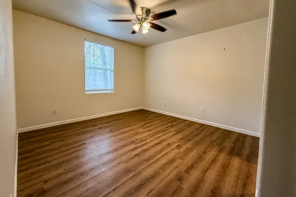wooden floor in an empty room with a window