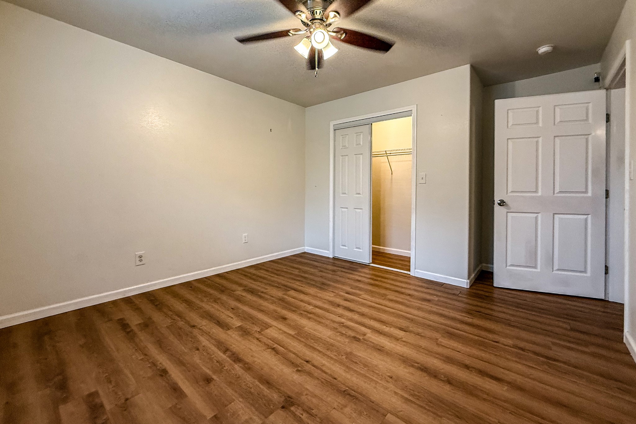 52 C Hank Benge Road Huntsville, TX 77320 - Photo 17 of 24 a view of an empty room with wooden floor