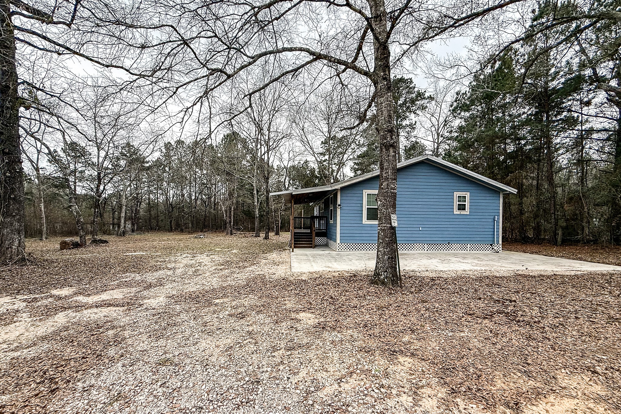 52 C Hank Benge Road Huntsville, TX 77320 - Photo 24 of 24 a house with trees in the background