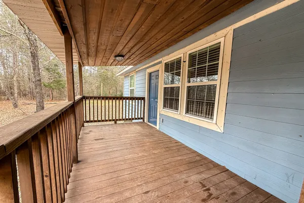 a view of porch with wooden floor and fence