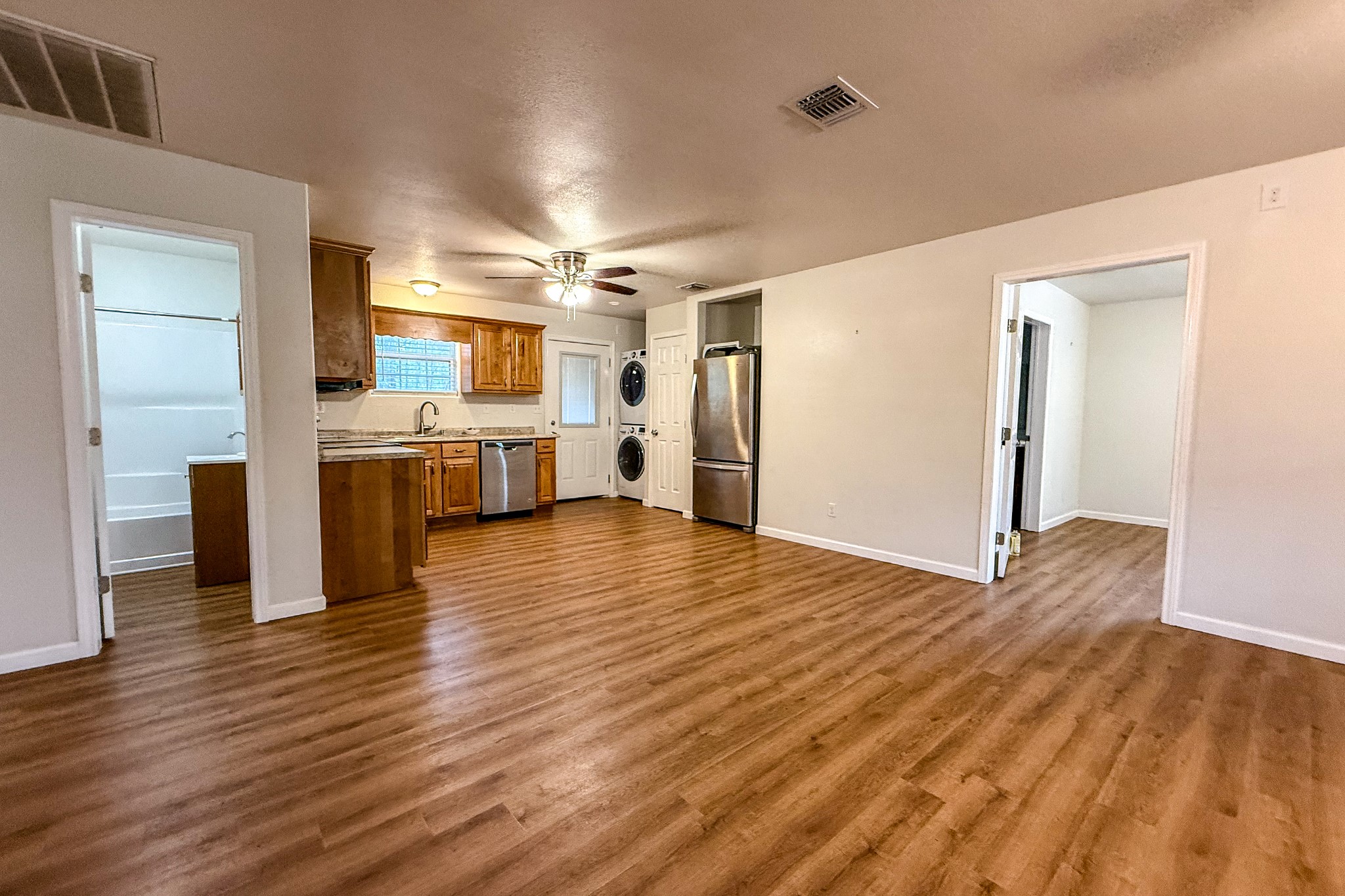 52 C Hank Benge Road Huntsville, TX 77320 - Photo 8 of 24 a view of a kitchen with wooden floor and a window