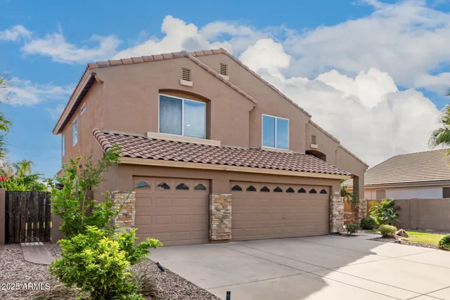 a view of an empty room with wooden floor fan and window