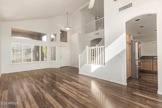a view of empty room with a fireplace and wooden floor