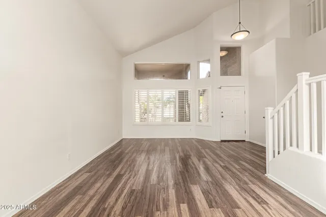 a view of a kitchen with a stove a kitchen island wooden floor and a ceiling fan