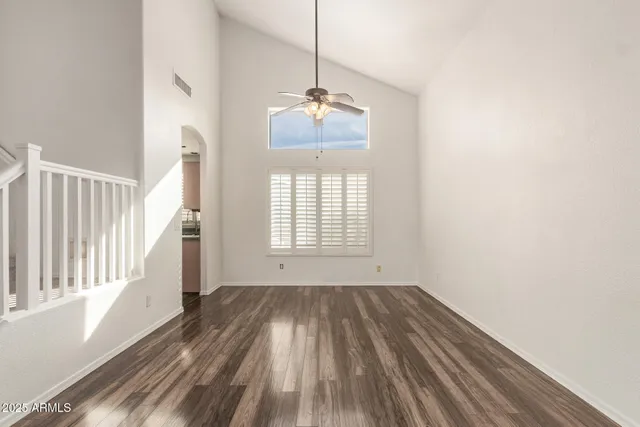 a view of an empty room with kitchen appliances and a window