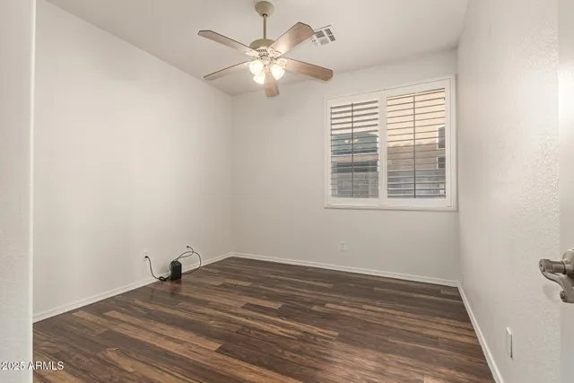 a spacious bathroom with stainless steel appliances granite countertop a sink and wooden floor