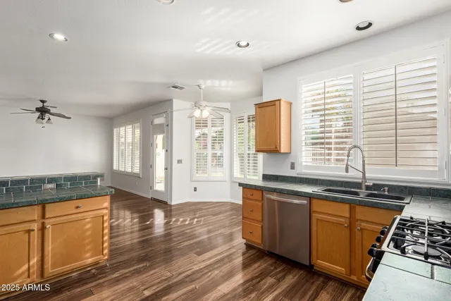 an empty room with closet and a ceiling fan