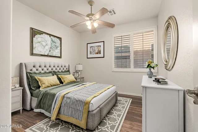 an empty room with windows and fan