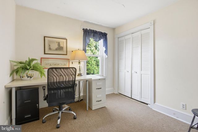 a bathroom with a sink a toilet and a window