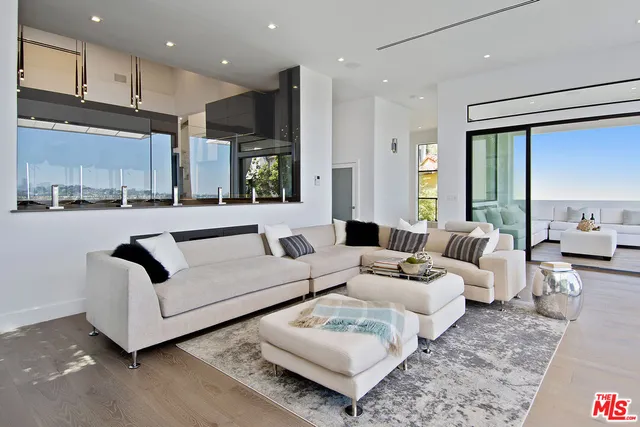 a view of a city from a balcony with furniture