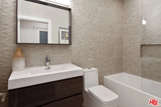 a large spacious bathroom with a large tub shower and sink