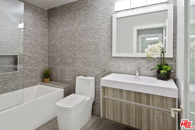 a view of a patio with couches table and chairs with potted plants