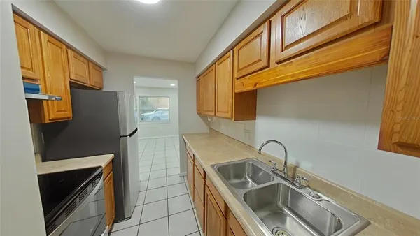 a kitchen with stainless steel appliances granite countertop a sink and a refrigerator