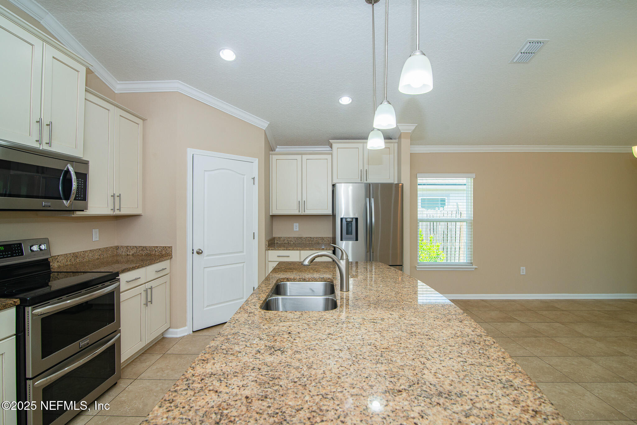 414 Samara Lakes Parkway St. Augustine, FL 32092 - Photo 12 of 26 a kitchen with granite countertop a stove and a sink
