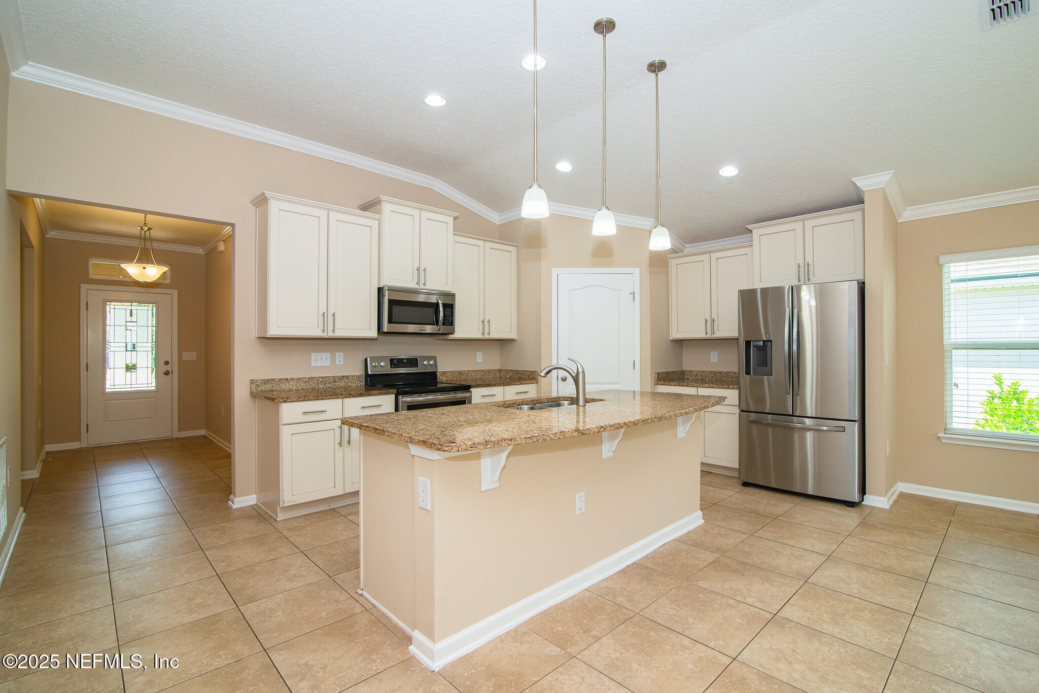 414 Samara Lakes Parkway St. Augustine, FL 32092 - Photo 13 of 26 a kitchen with stainless steel appliances granite countertop a refrigerator a stove a sink a microwave and a refrigerator