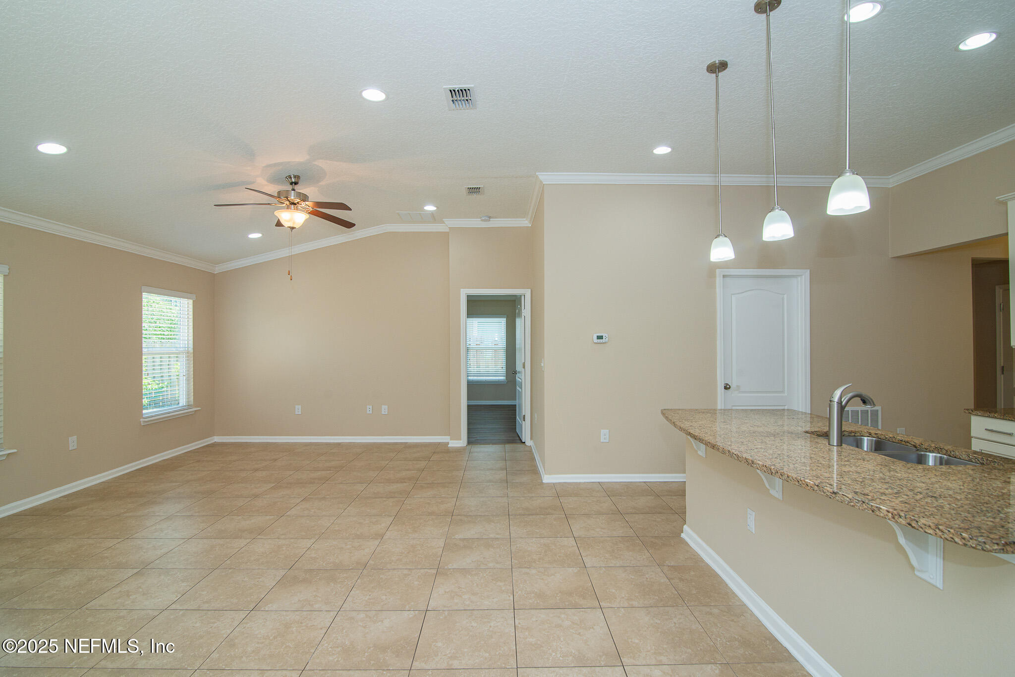 414 Samara Lakes Parkway St. Augustine, FL 32092 - Photo 14 of 26 a bathroom with a granite countertop sink a large mirror and a shower