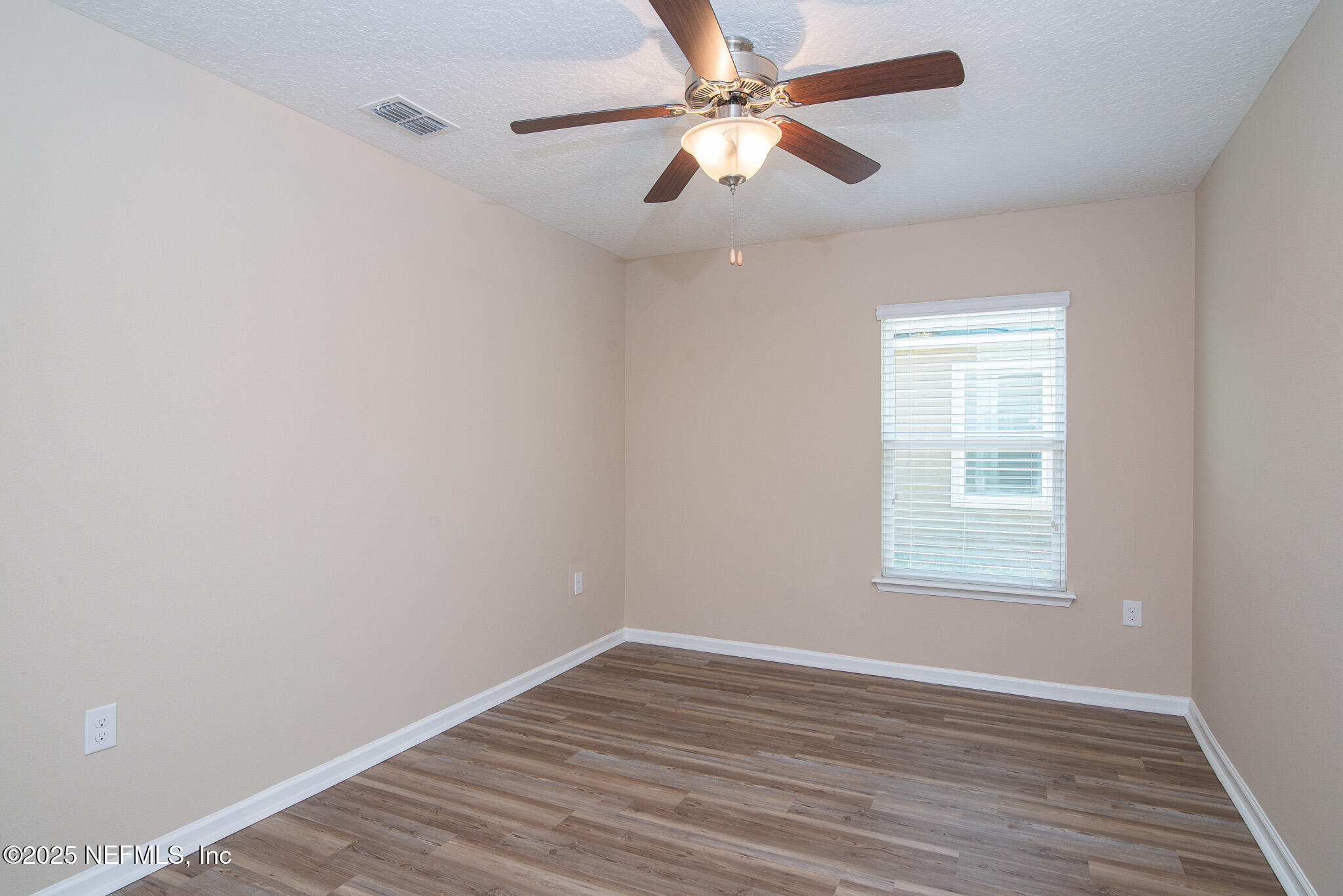 414 Samara Lakes Parkway St. Augustine, FL 32092 - Photo 16 of 26 wooden floor in an empty room with a window