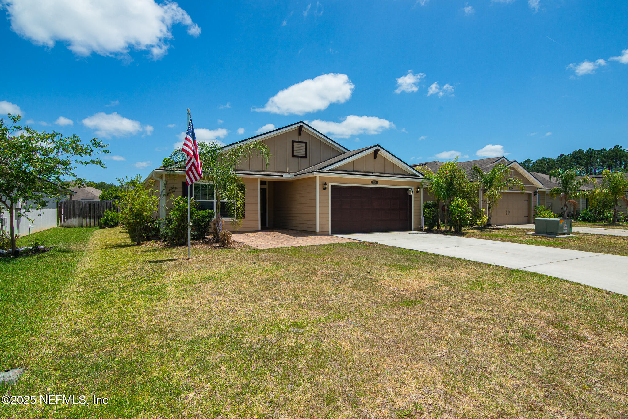 414 Samara Lakes Parkway St. Augustine, FL 32092 - Photo 2 of 26 a front view of a house with garden