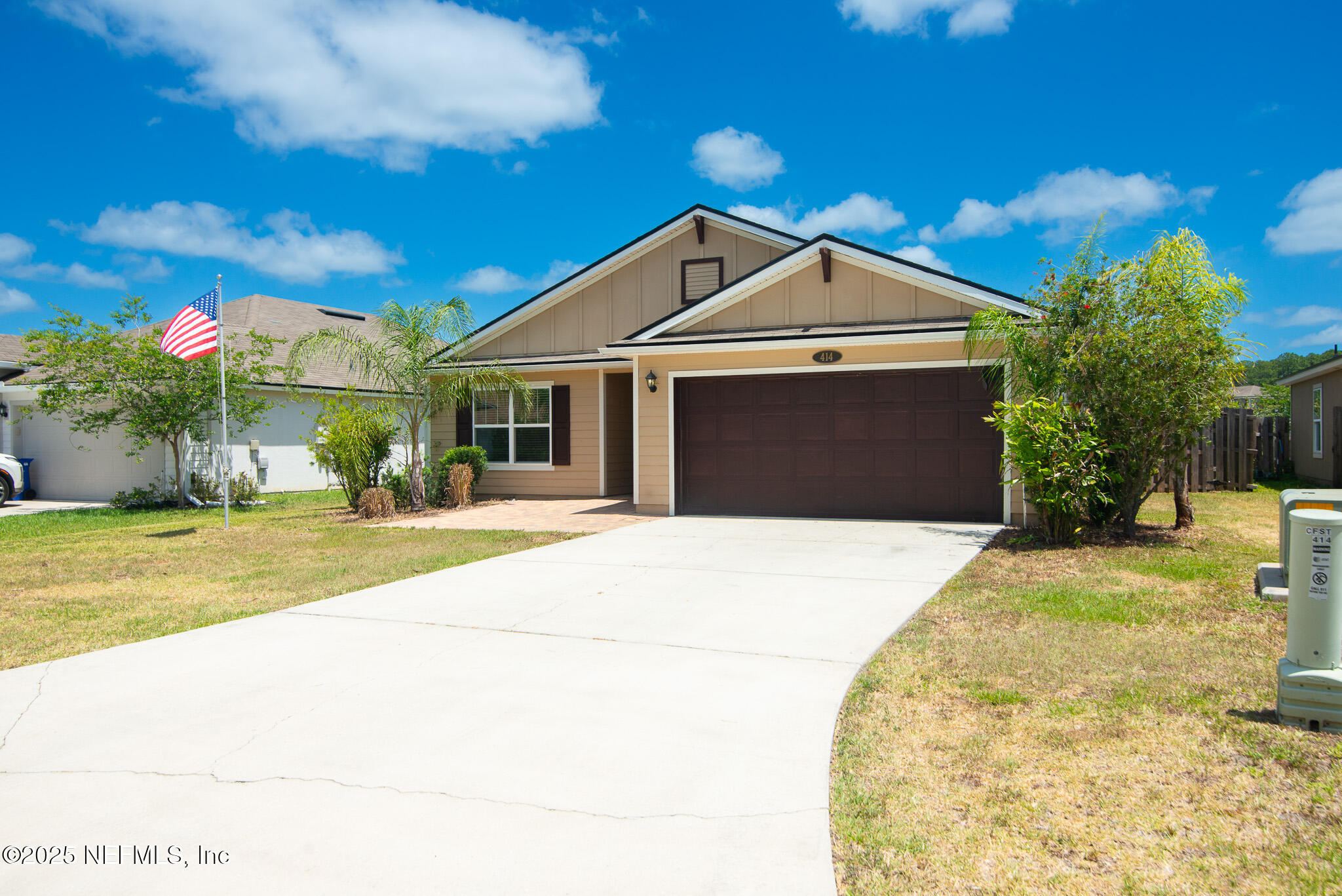 414 Samara Lakes Parkway St. Augustine, FL 32092 - Photo 3 of 26 a front view of a house with a yard and potted plants