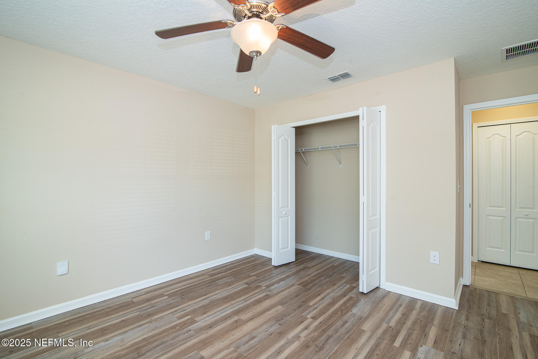 414 Samara Lakes Parkway St. Augustine, FL 32092 - Photo 7 of 26 a view of an empty room with wooden floor