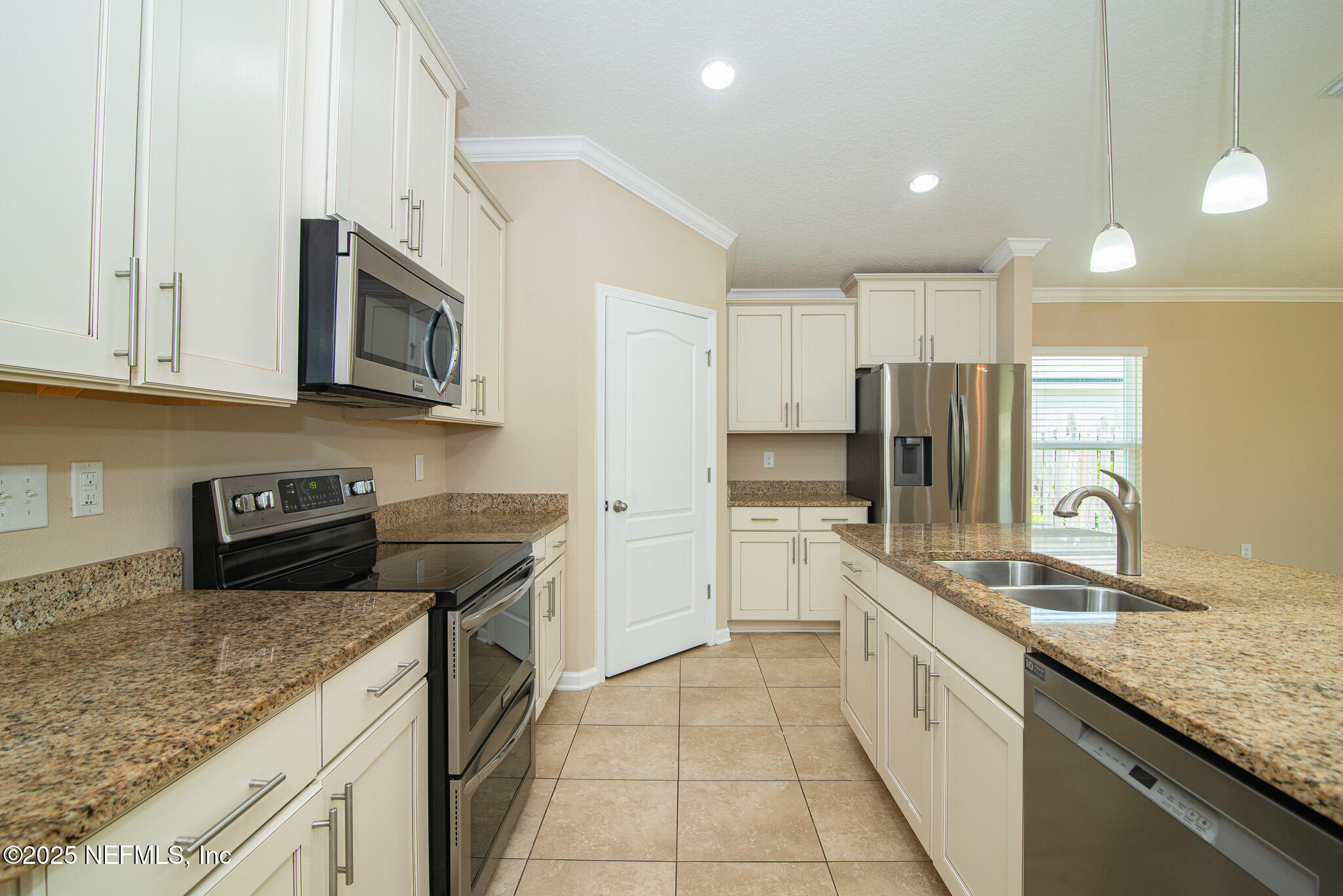 414 Samara Lakes Parkway St. Augustine, FL 32092 - Photo 10 of 26 a kitchen with stainless steel appliances granite countertop a sink stove and refrigerator