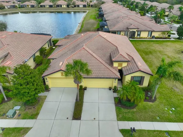 an aerial view of a house with swimming pool and patio