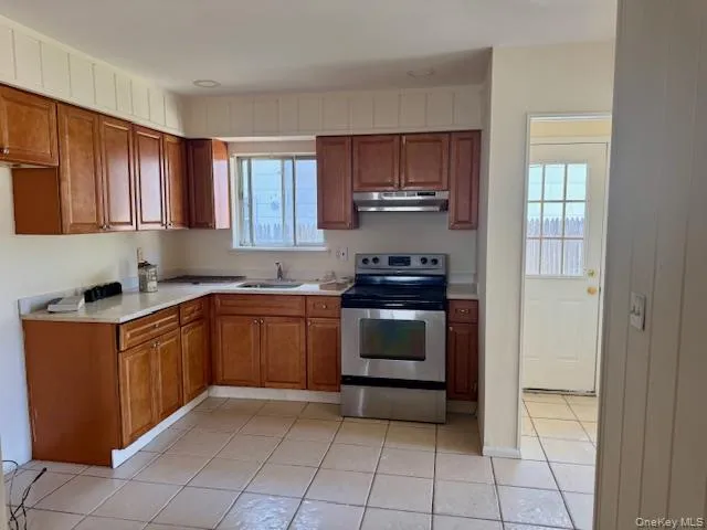 a kitchen with stainless steel appliances granite countertop a stove top oven and cabinets
